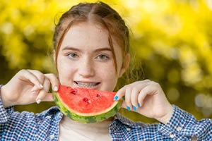 Woman smiling while holding a watermelon