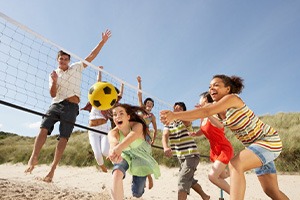 Group of friends playing volleyball on the beach